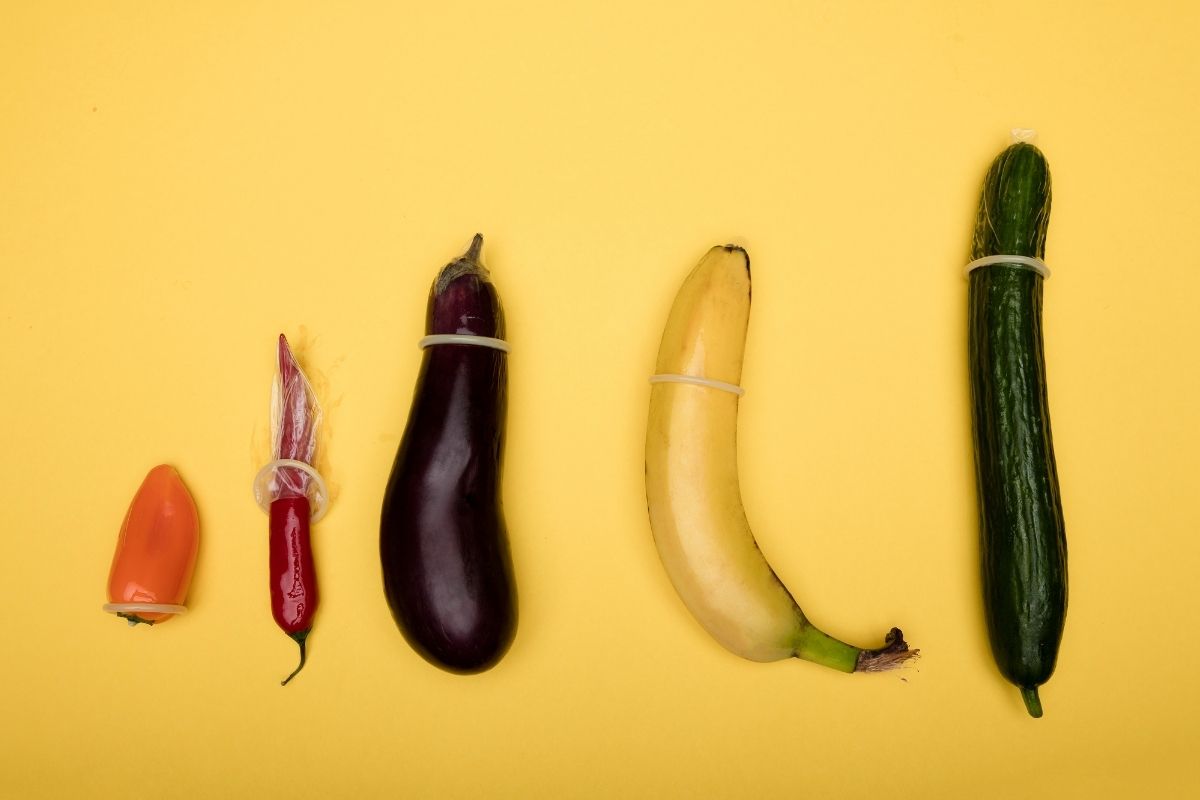 Condoms on different sized fruit and vegetables